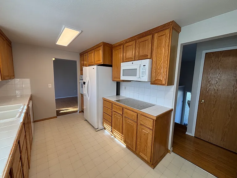 View of the large kitchen including the brand new microwave and cooktop