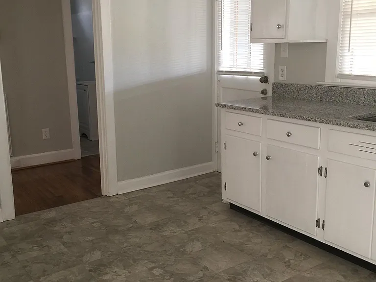 Eat-in Kitchen. Tenant provides refrigerator. Two bedrooms and a full bathroom off the kitchen to the left.