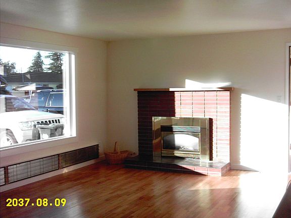 family room with hardwoods and gas fireplace insert