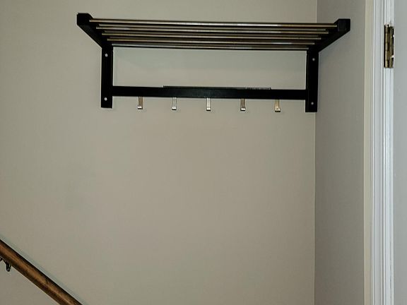 Shelving unit behind front door for keys, coats/jackets, etc