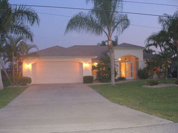 house front at night with double garage