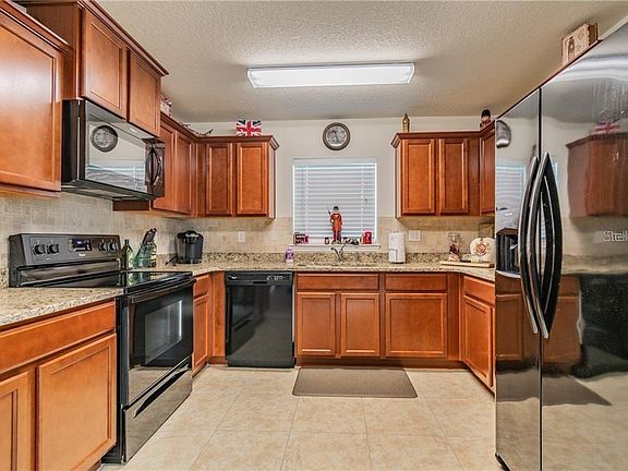 Kitchen features granite countertops and stainless steel appliances
