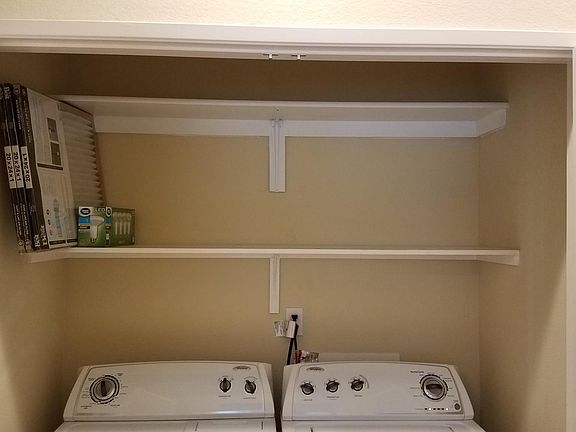 Laundry in unit with extra storage.