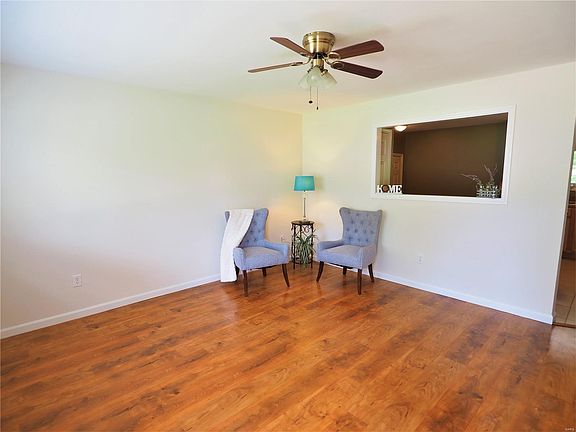 Come on in!  The open and spacious living room has wood flooring, freshly painted and trimmed, updatied lighting and access to kitchen area