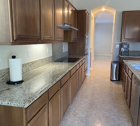 granite countertops, lots of hide away storage and walk in pantry