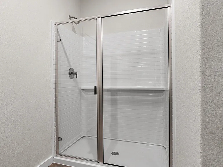 The master bathroom has a glass, walk-in shower.