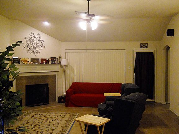 Living room is tiled and has high ceilings and plenty of space