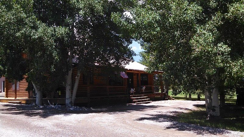 Home Front Entrance
						:
						Nestled behind mature aspen trees