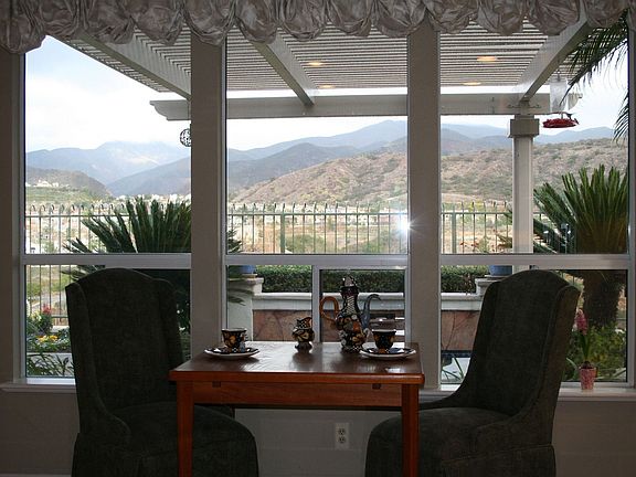 Cozy kitchen nook takes in the scenery through large picture windows