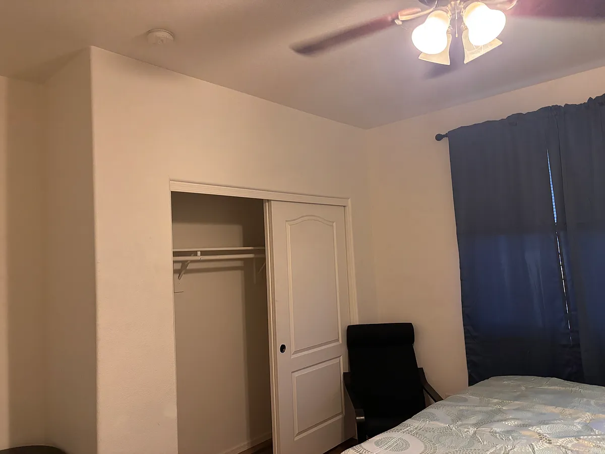 Downstairs bedroom 1. Furnished with linens, celing fan, California King waterbed, chair, curtins, LVP flooring, fresh paint. - N 143rd Ave