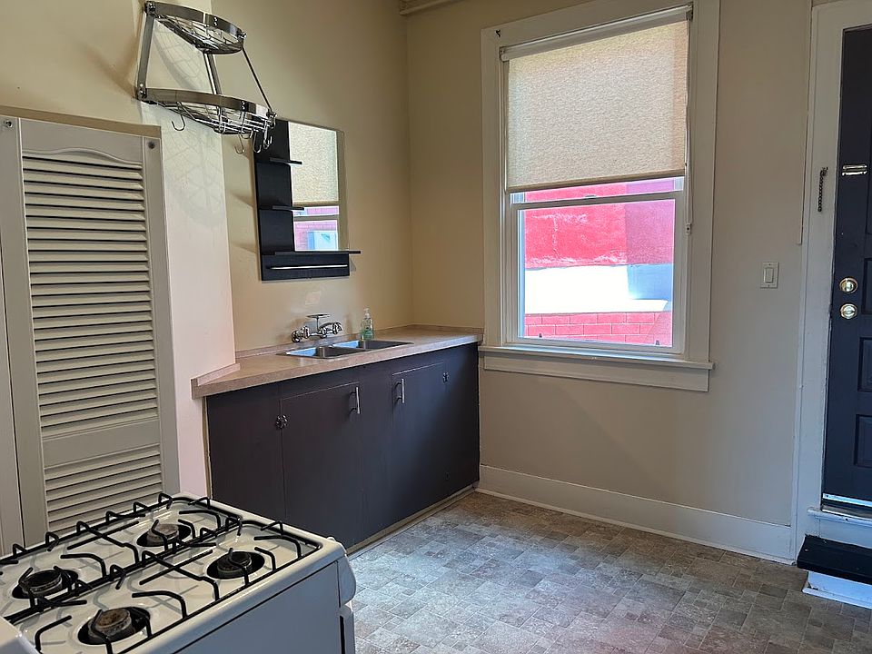Separate kitchen area with room for a small table/chairs near window.