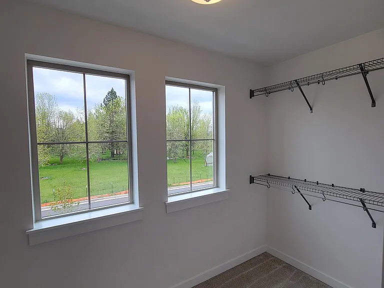 Master bedroom closet with 2 windows