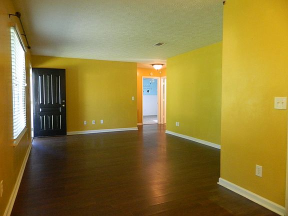 Open floorplan with plantation blinds and hardwood throughout