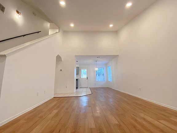 Laminate flooring, open space living and dining area