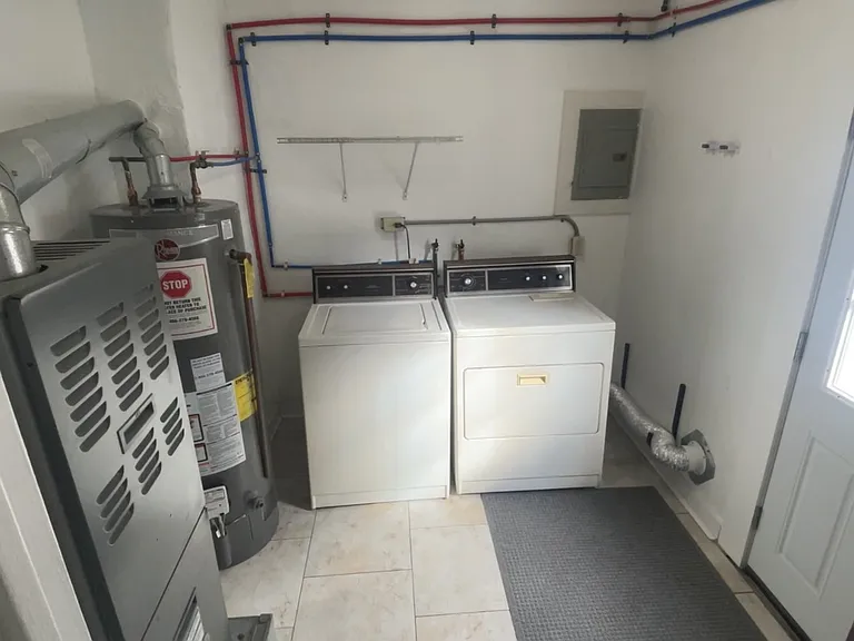 Kitchen leading into laundry room. Side entry door to the right.