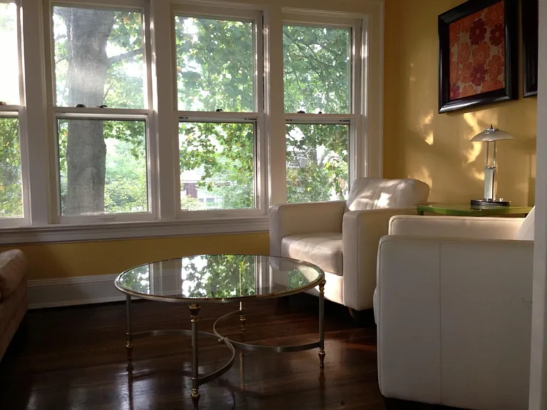 Sunroom with six windows. All walls are now grey.