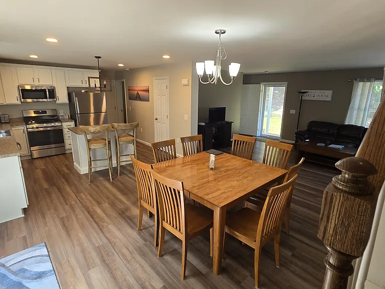 Spacious kitchen with seating at island. and a table for 8