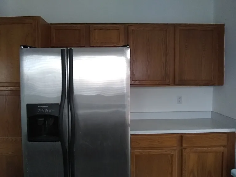 kitchen refrigerator beside pantry