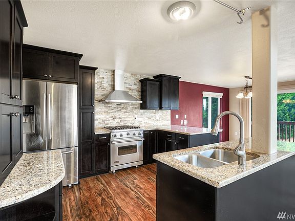 Featuring beautiful hardwood flooring and full tile back splash