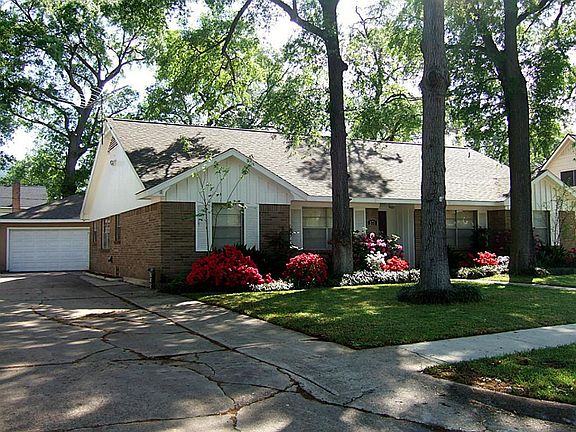 Lush landscape mature trees, double wide driveway, 2-car detached oversize Garage and newly stained front door.