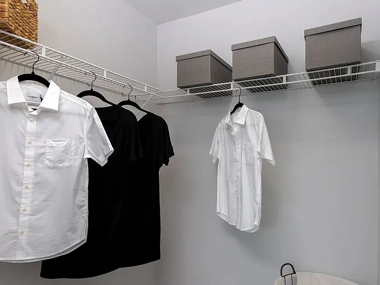 Step into the secondary bedroom's walk-in closeta curated space for ultimate organization, boasting meticulously arranged shelves and ample storage solutions.