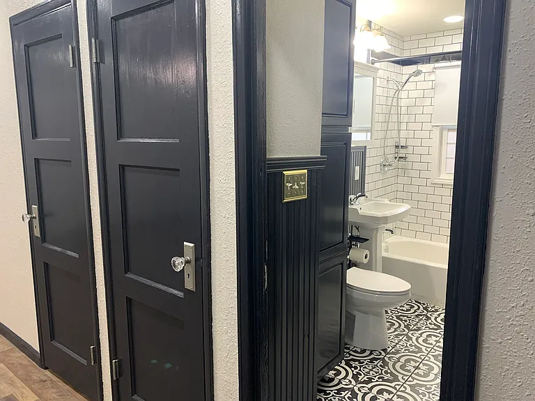 View of closet and bathroom from hallway