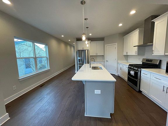 Space for a dining room table and island seating. Large pantry for storage.