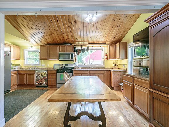 Closer view into the kitchen with beautiful wood ceiling