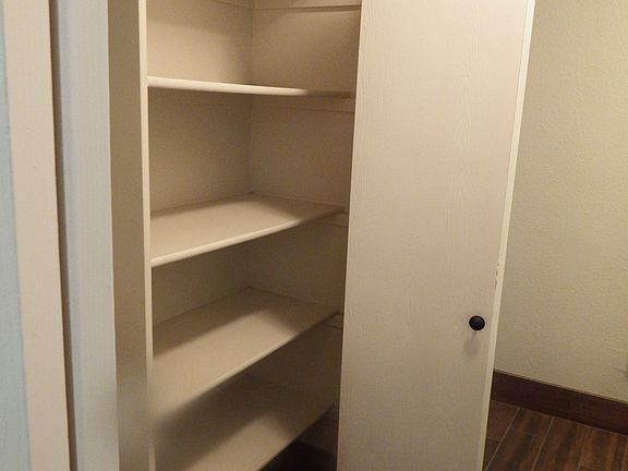 Entry coat closet with extra additional shelving.