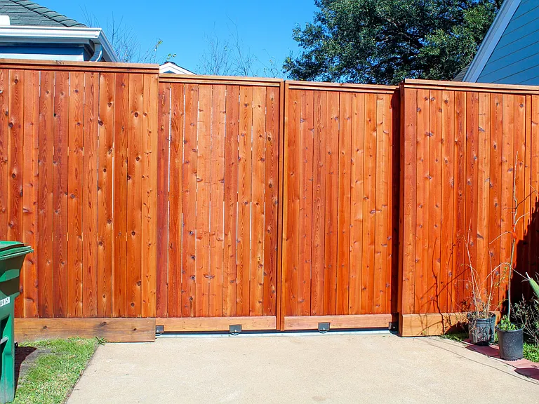 Outside the cedar fence with gates closed along with shared trash bin and recycling bin. Lawn maintenance included in rent.