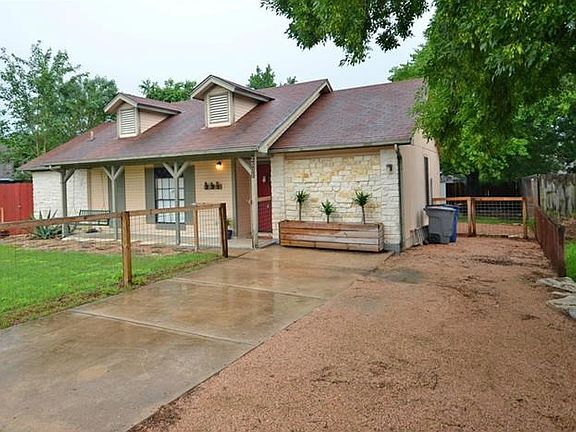 Paved driveway and additional parking in gravel area.