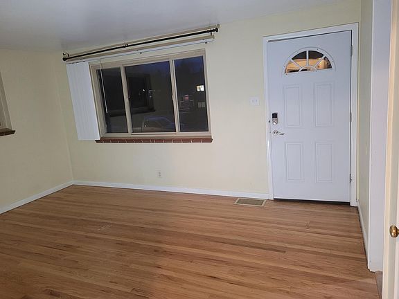 Living room view of front door and front window.