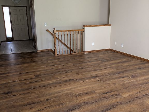 Main living space, access to lower level. New luxury vinyl plank extends through the kitchen and laundry room.
