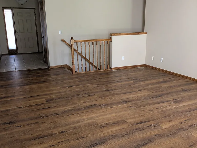 Main living space, access to lower level. New luxury vinyl plank extends through the kitchen and laundry room.