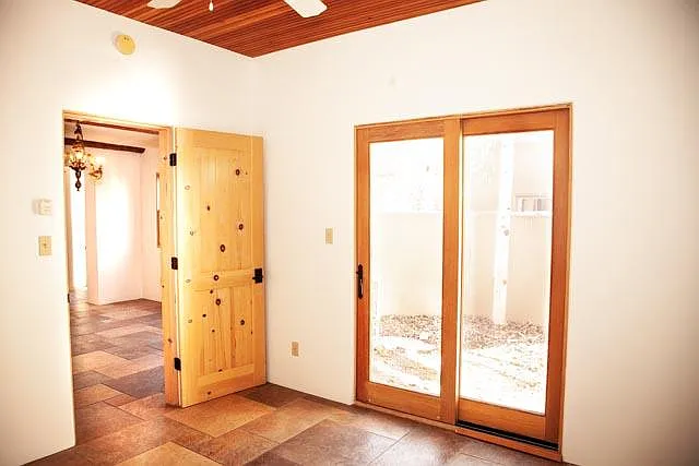 This third room makes an ideal office or guest bedroom off the dining area. It features more high, tongue-and-groove ceilings, a fan, heated floors and its own private sunny patio.