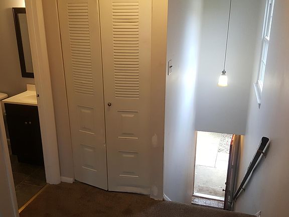 Looking down the steps to the front. At the top, there's a coat closet and bathroom in the living room.