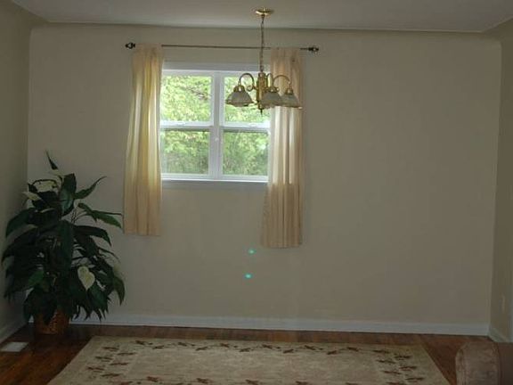 Dining area located at one end of the living room and adjacent to the  kitchen.