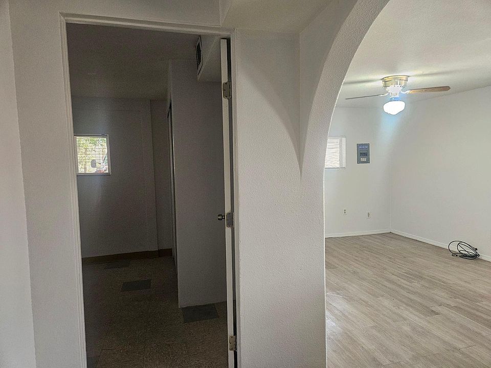 View of living room and bedroom from hallway.