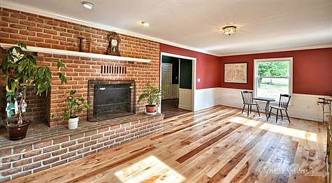 Living room with brick fireplace crown and chair railing