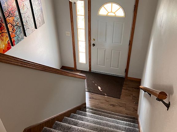 Entry door with stairs to upper "main" floor or to lower level.