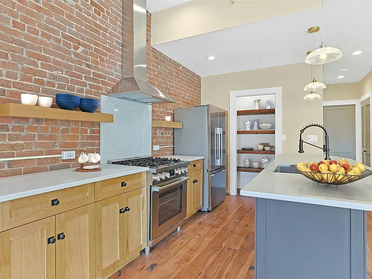 Kitchen featuring all new stainless steel appliances and custom pantry.