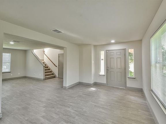17x11 Living Room - Looking back toward the front door and the Dining Room to the left. The half bathroom is located at the foot of the stairs.