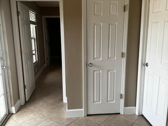 Doorway to master bedroom (open), utility closet (middle door), and bathroom door to the right