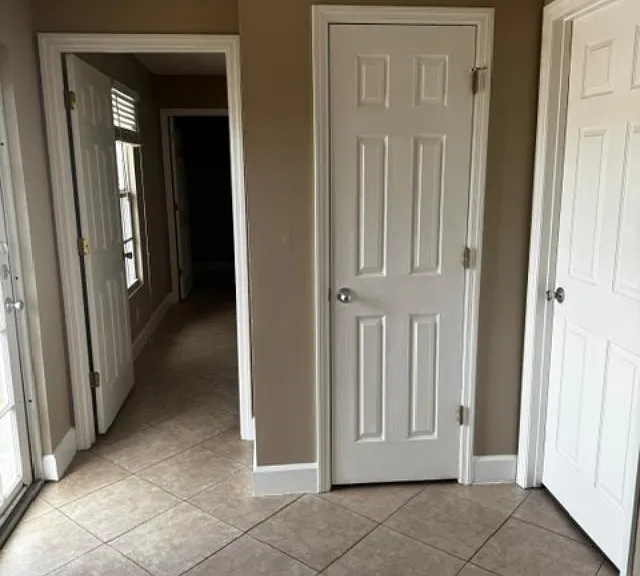 Doorway to master bedroom (open), utility closet (middle door), and bathroom door to the right