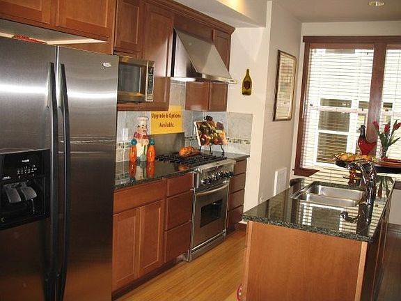 Kitchen features stainless appliances,hardwood floors,granite counters & more!