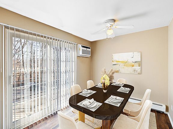 Formal dining room with ceiling fan and doorwall