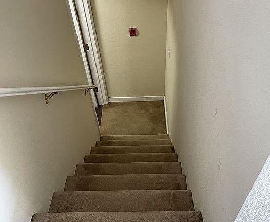 Stairs beginning from the entrance of the studio apartment (top floor)