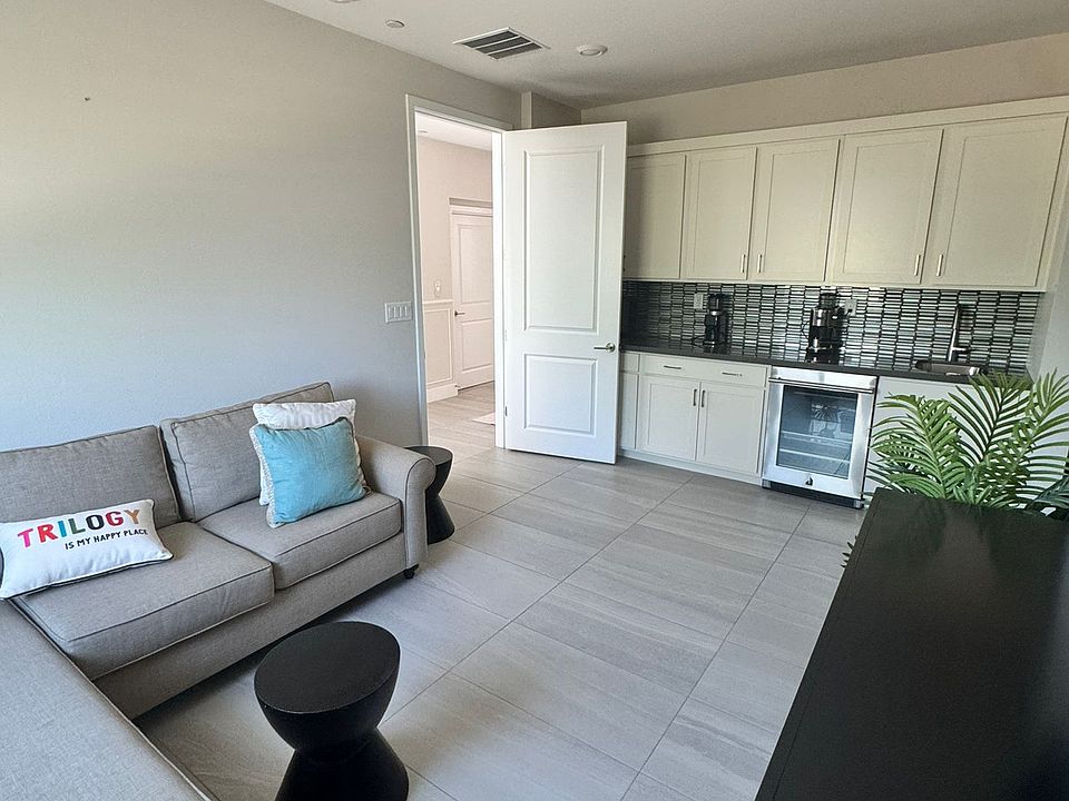 Ground-floor retreat with designer upgrades, curated furnishings, and a modern wet bar_perfect for hosting in style.