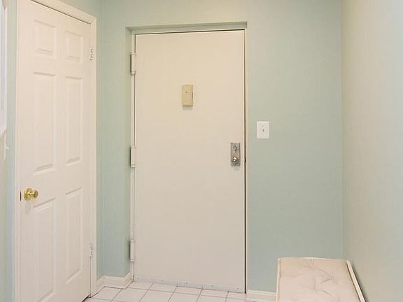 Foyer with ceramic tile.