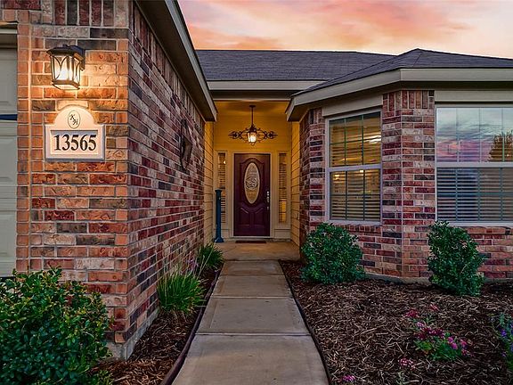 Colorful landscaping and upgraded solid steel door grace the front porch.